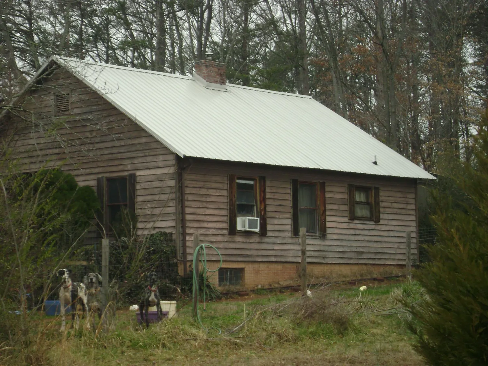 White metal roof on an old wood sided farmhouse, from a Metal Roof Installation job in West Ossipee